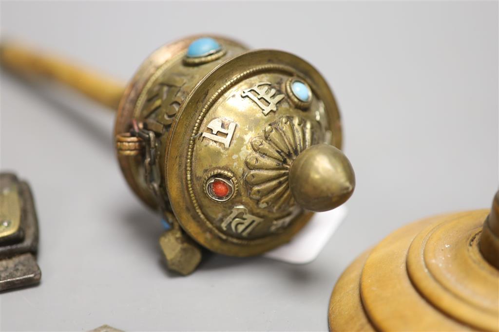 A Tibetan brass prayer wheel, inset with cabochons, with turned wood handle and four other items,